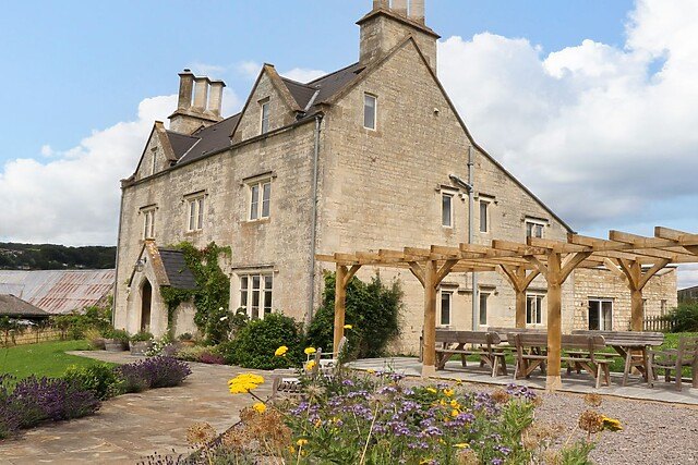 Hammonds Farmhouse near Stroud, a Cotswold stone group cottage sleeping 16 with a pergola and garden