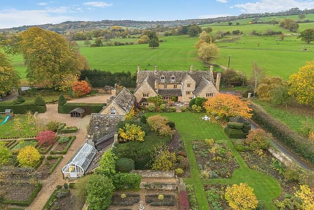 Aerial view over The Fold and the gardens and rooftops of Broadway in the Cotswolds